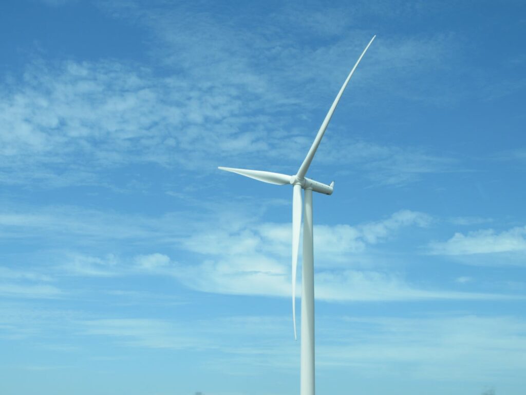 A wind turbine under a clear blue sky in Bo-Karoo, promoting renewable energy solutions.
